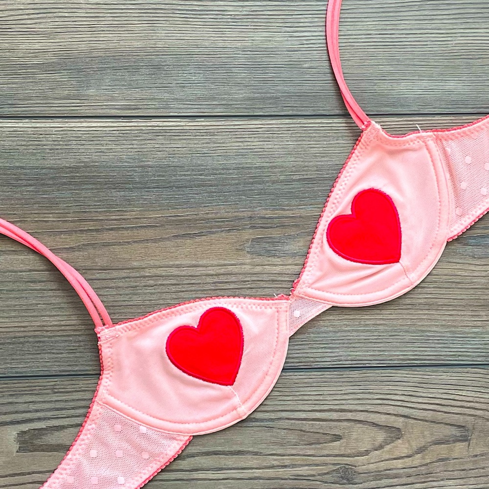 Out From Under pink bra with red heart patches in size S